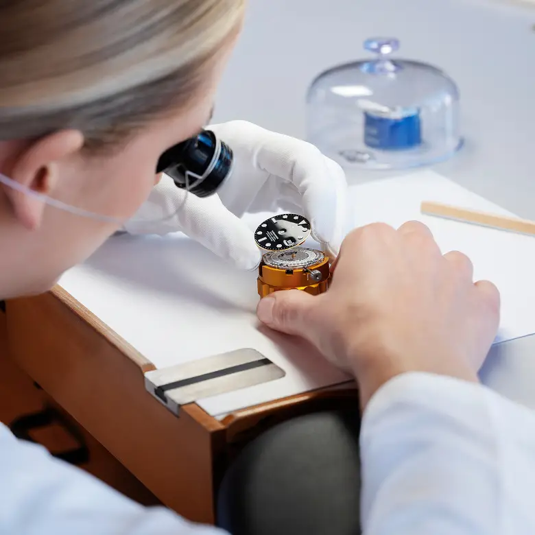 Rolex watchmaker servicing a movement